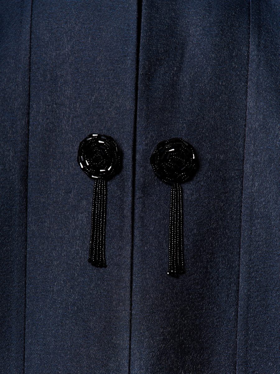 Close-up of beaded tassel closures on a navy abaya